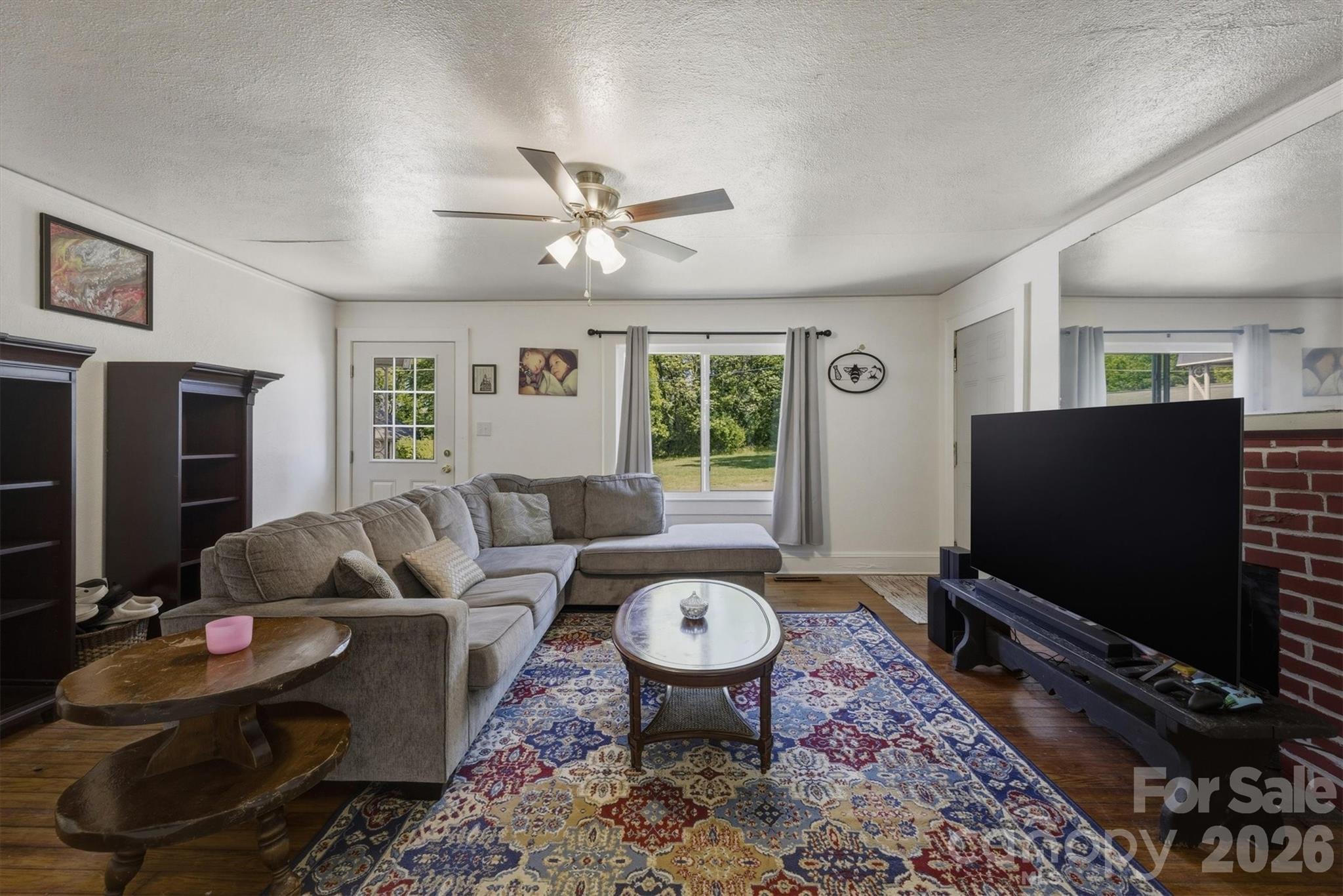 117 3rd Avenue Southwest Hickory, NC 28602 - Photo 10 of 21 a living room with furniture a flat screen tv and a window