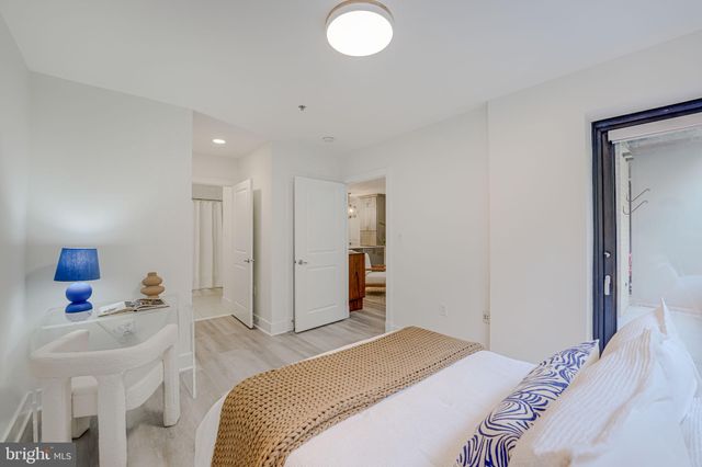 a bedroom with a bed and a lamp