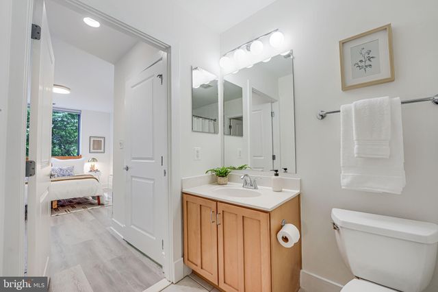 a spacious bathroom with a sink mirror toilet and a bath tub