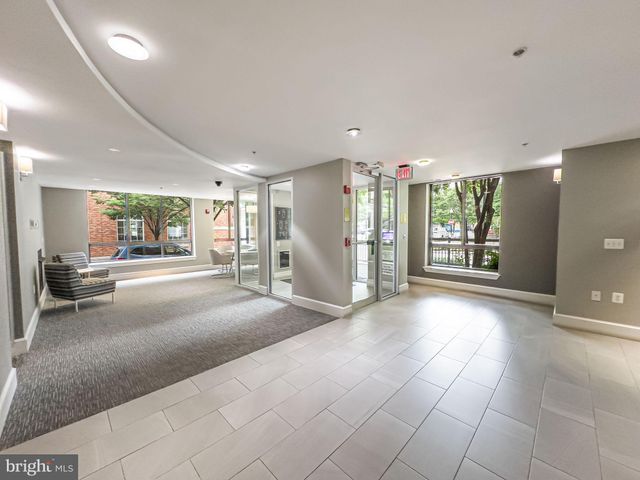 a living room with furniture and large windows