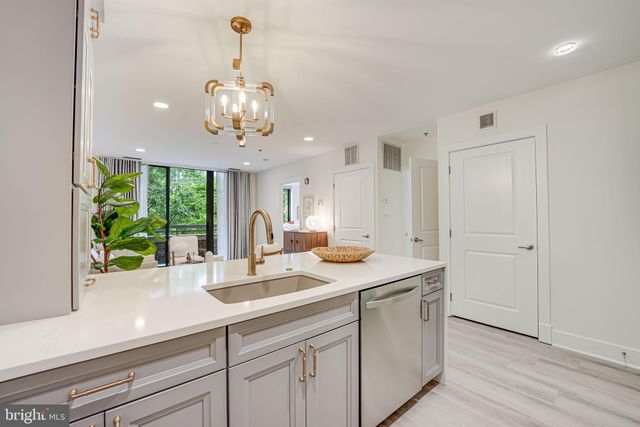 a kitchen with a sink and chandelier