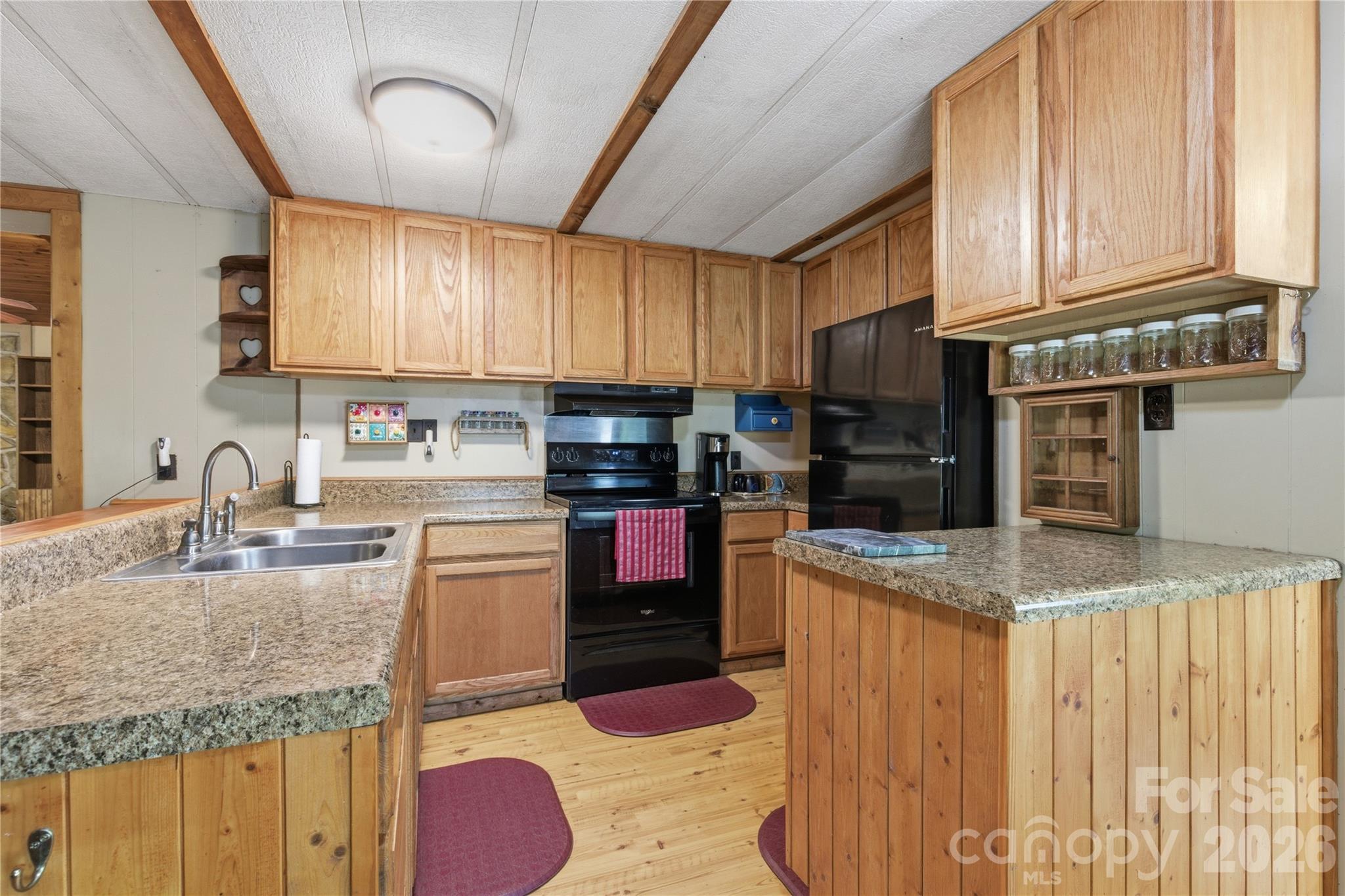 159 Volley Ellenboro, NC 28040 - Photo 22 of 37 a kitchen with stainless steel appliances granite countertop a sink a stove and a wooden cabinets