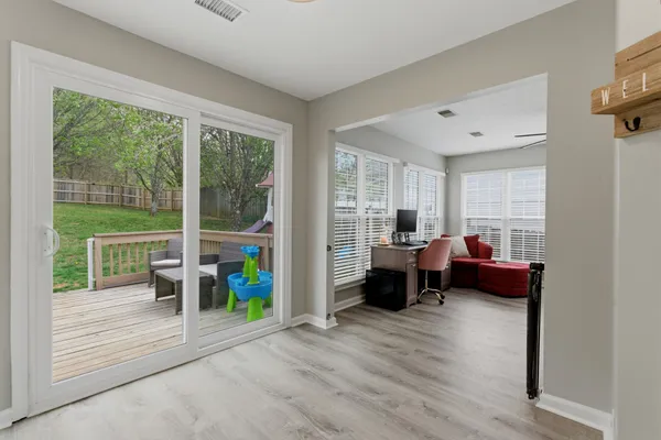 a living room with furniture and a floor to ceiling window