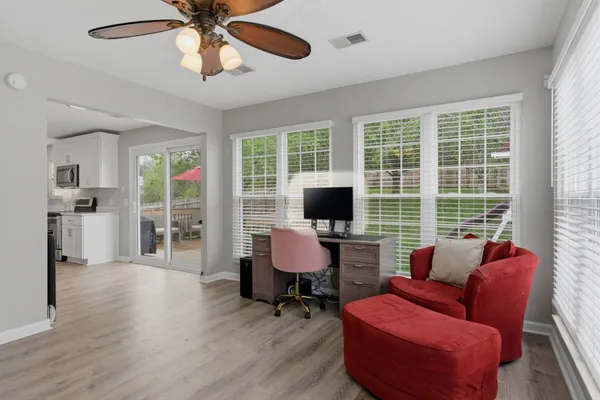a view of a livingroom with workspace and a window