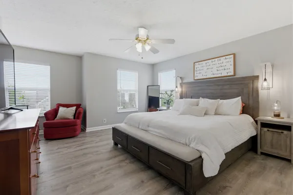 a spacious bedroom with a bed and window