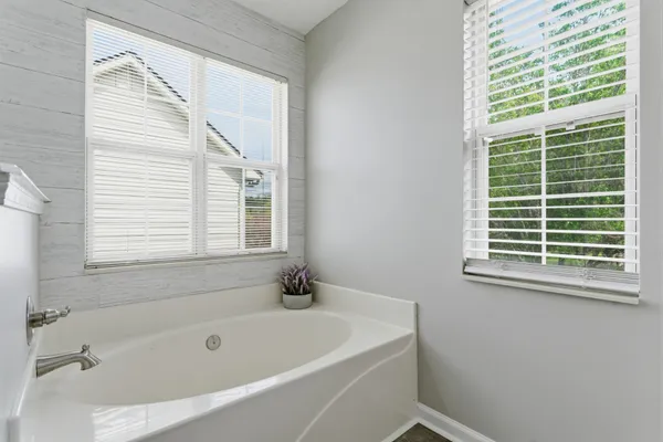 a white bath tub sitting next to a window