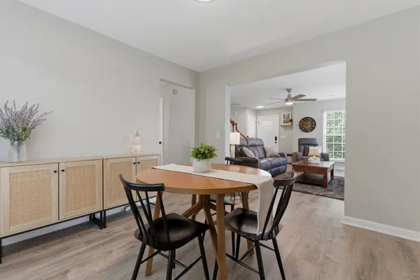 a view of a dining room with furniture and wooden floor