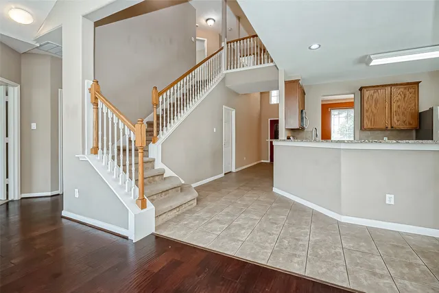a view of entryway and hall with wooden floor