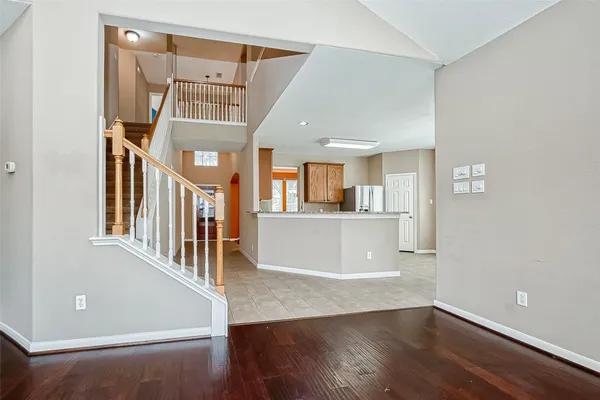 a view of entryway and hall with wooden floor
