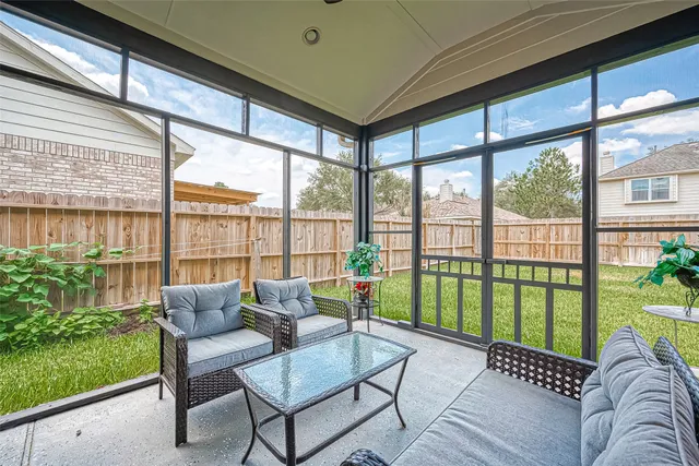a living room with furniture and a floor to ceiling window