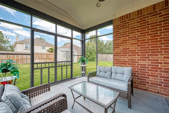 a balcony with furniture and a potted plant