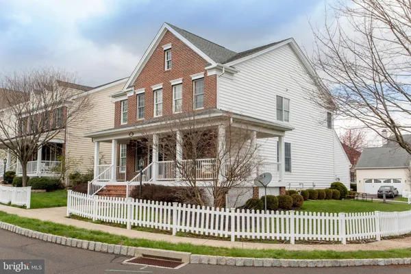 a front view of a house with a fence