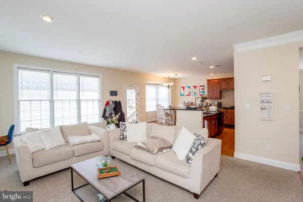 a living room with fireplace furniture and a chandelier