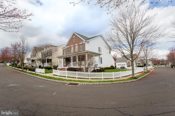 a view of a house with a big yard and large trees