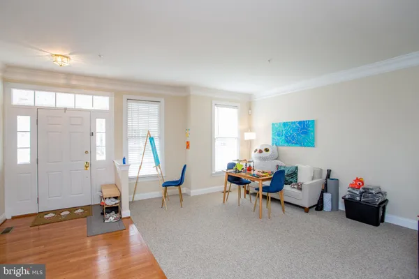 a living room with furniture toys and a window