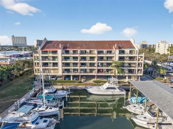 a roof deck with table and chairs and a barbeque