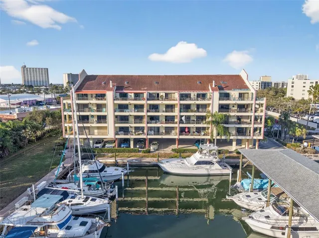 a roof deck with table and chairs and a barbeque