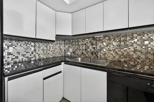 a close view of sink and cabinets