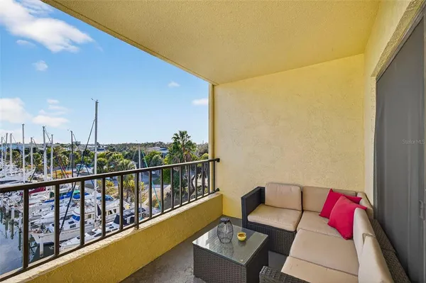a balcony with furniture and wooden floor
