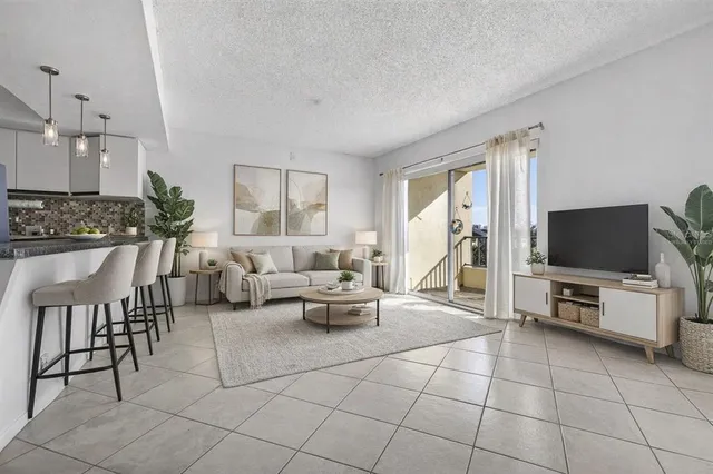 a living room with furniture a flat screen tv and a large window