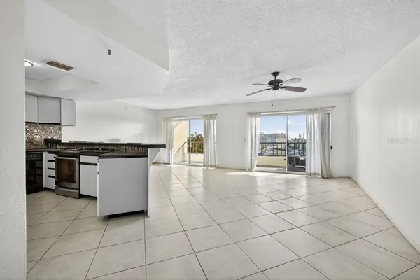 a view of a kitchen with furniture and an empty room