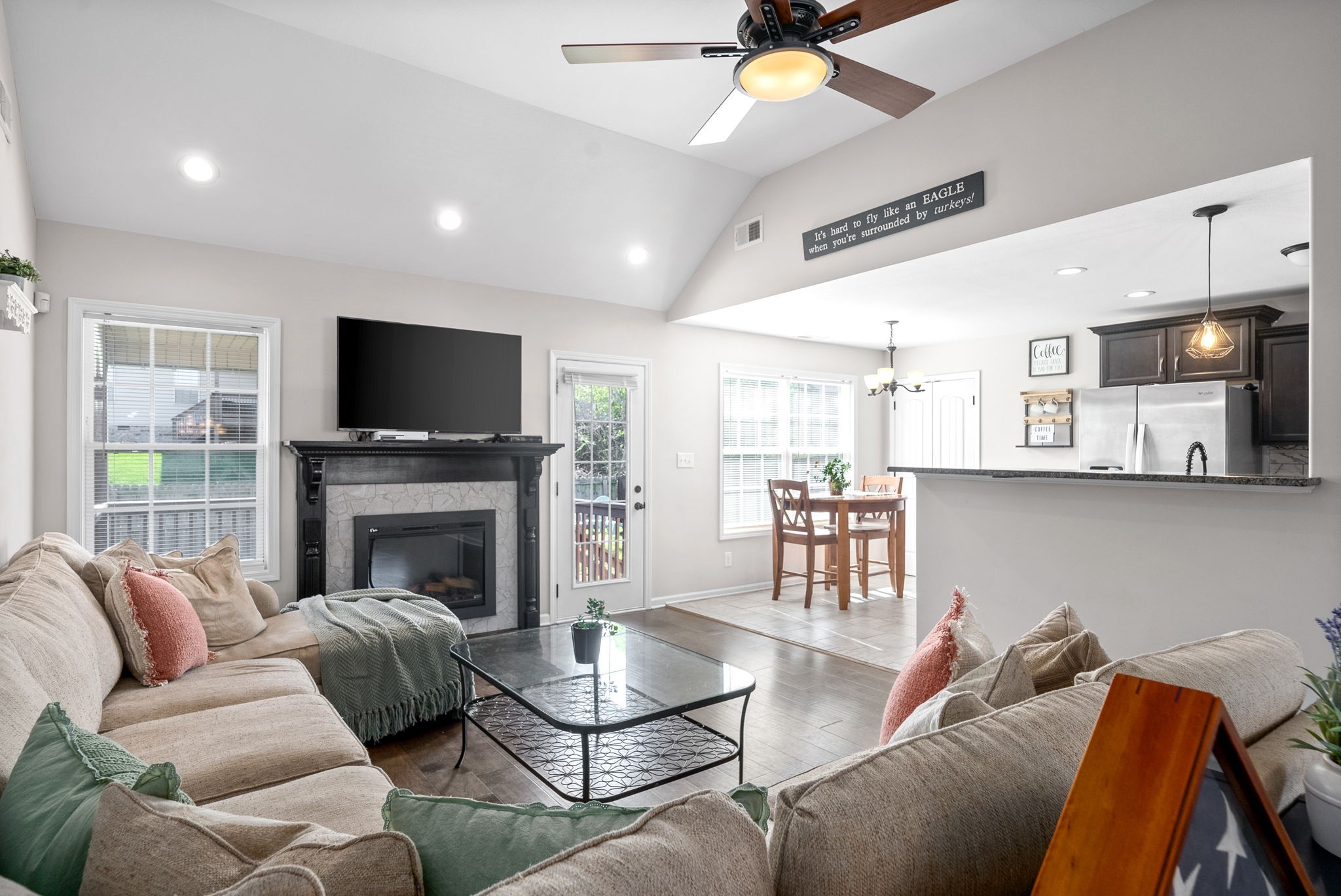 1478 Raven Road Clarksville, TN 37042 - Photo 8 of 42 a living room with furniture a flat screen tv and kitchen view