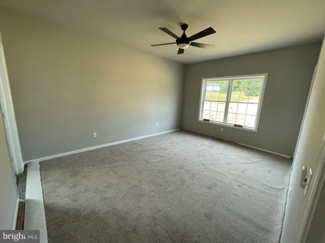 an empty room with a empty space and windows