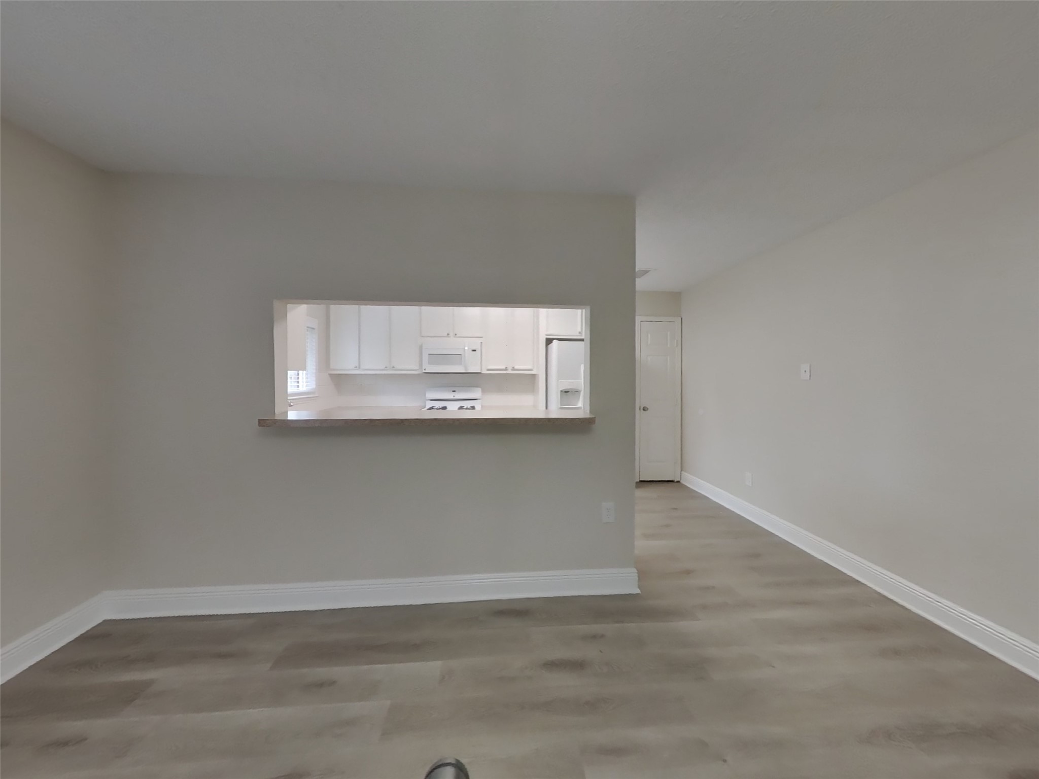 9607 Cleveland Bay Court Houston, TX 77065 - Photo 5 of 18 an empty room with wooden floor and cabinets
