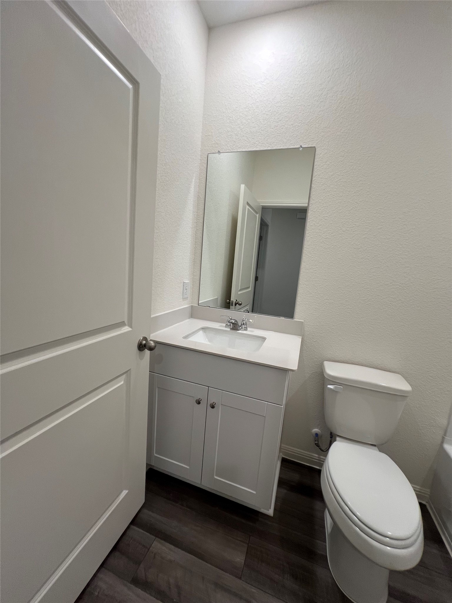 124 Rother Place Taylor, TX 76574 - Photo 9 of 12 A well-appointed bathroom with a sleek vanity and modern dark flooring.