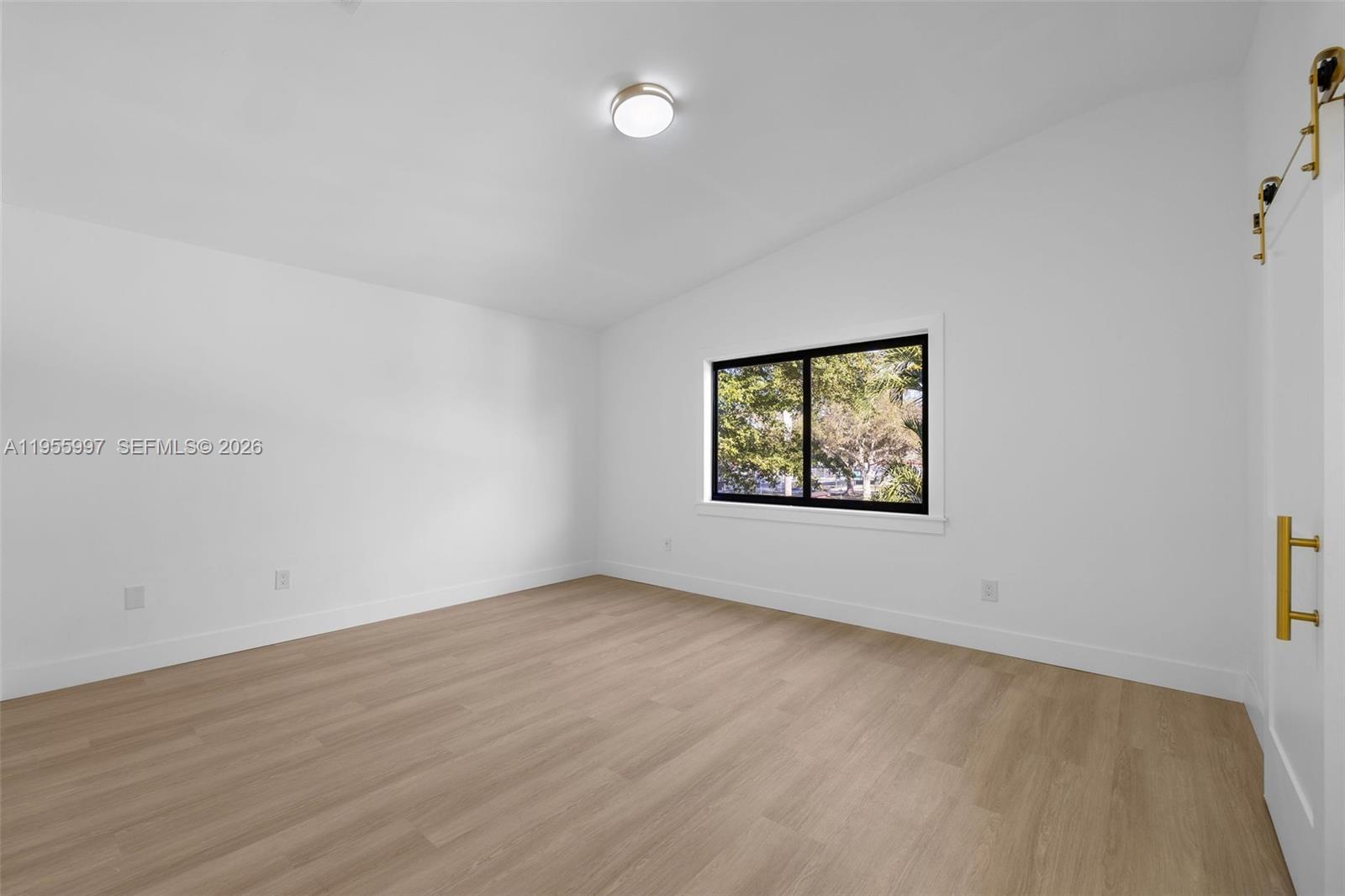 11260 Southwest 157th Court Miami, FL 33196 - Photo 14 of 29 an empty room with wooden floor and windows