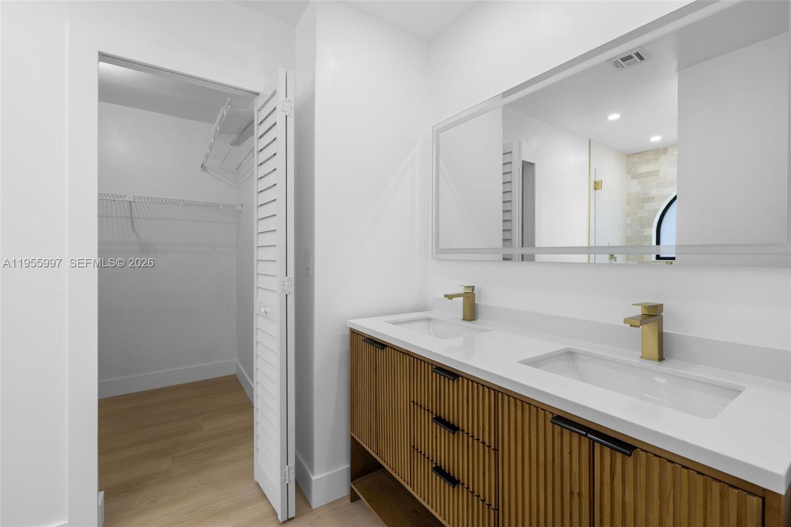 11260 Southwest 157th Court Miami, FL 33196 - Photo 16 of 29 a bathroom with a sink a mirror and shower