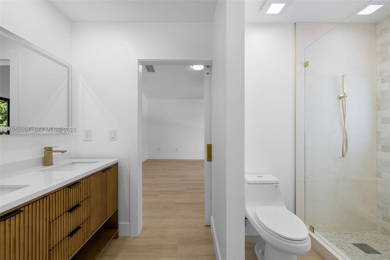 11260 Southwest 157th Court Miami, FL 33196 - Photo 18 of 29 a bathroom with a granite countertop sink toilet and shower