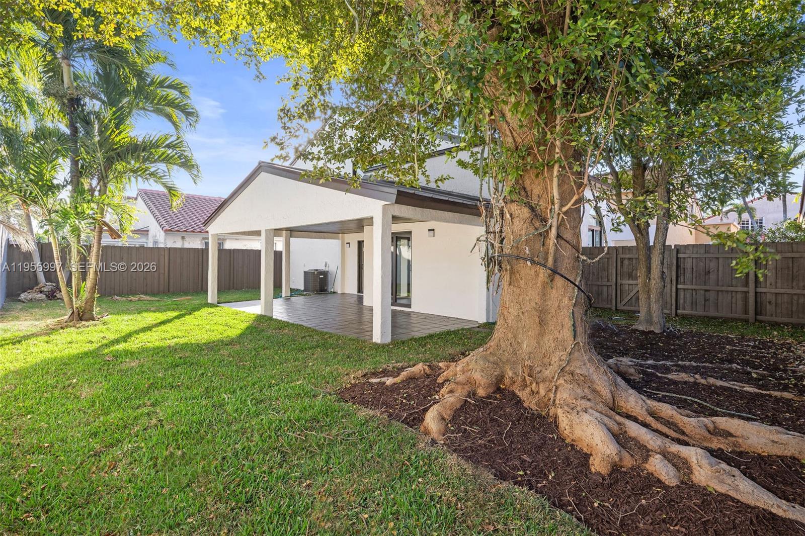 11260 Southwest 157th Court Miami, FL 33196 - Photo 25 of 29 a view of a yard in front of a house with a large tree