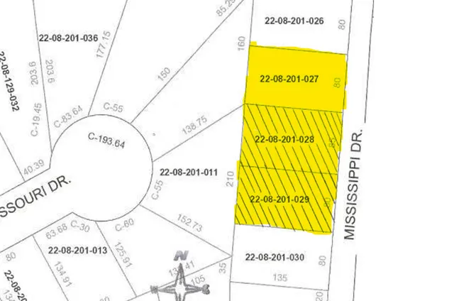 a view of an ocean with large trees