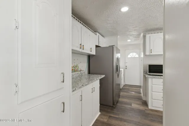 a kitchen with stainless steel appliances granite countertop a refrigerator and a sink