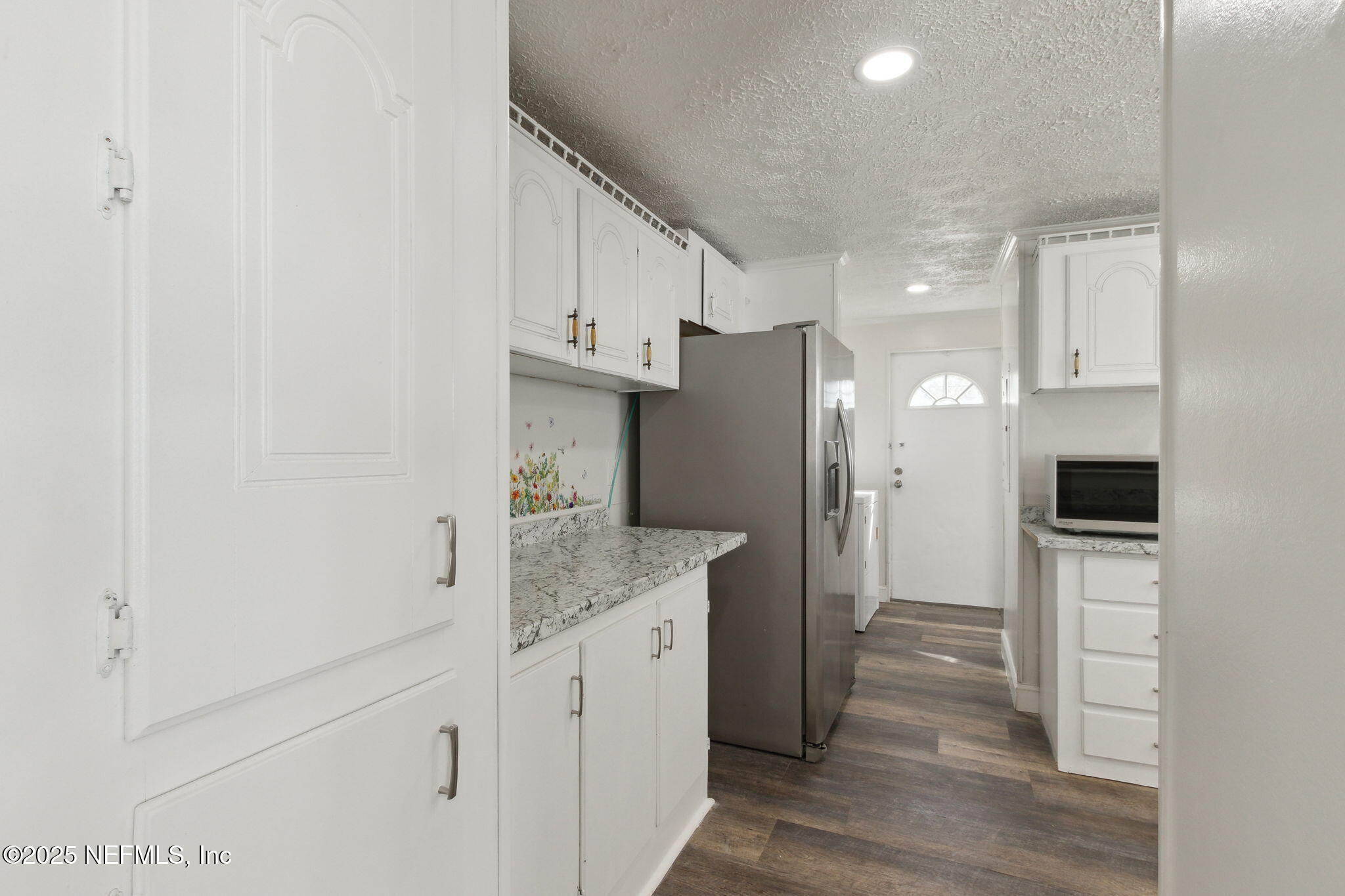 97119 Diamond Street Yulee, FL 32097 - Photo 15 of 42 a kitchen with stainless steel appliances granite countertop a refrigerator and a sink