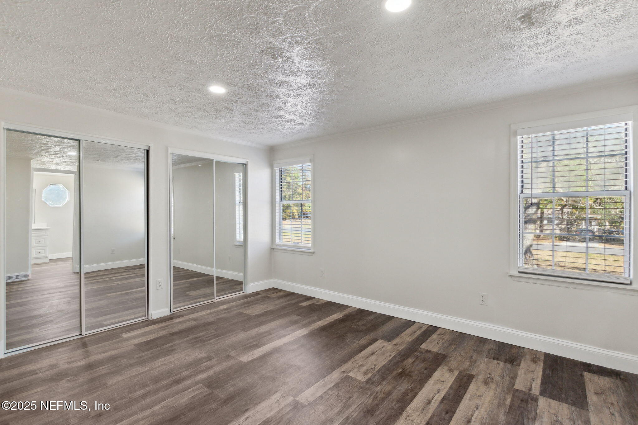 97119 Diamond Street Yulee, FL 32097 - Photo 18 of 42 an empty room with wooden floor and windows