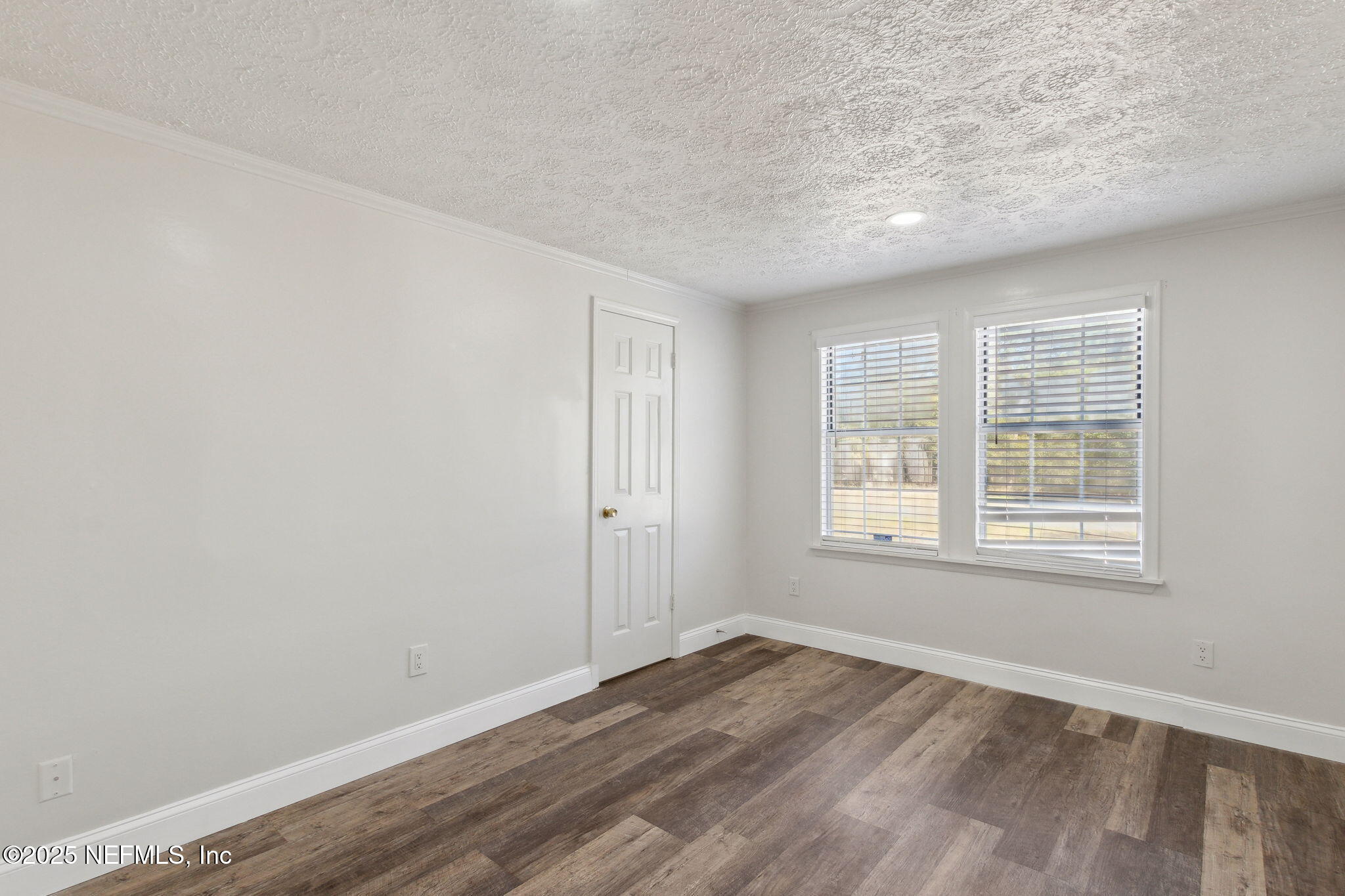 97119 Diamond Street Yulee, FL 32097 - Photo 23 of 42 an empty room with wooden floor and windows