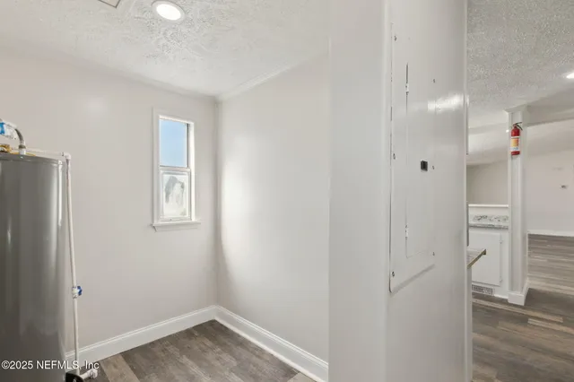 a view of a hallway with wooden floor