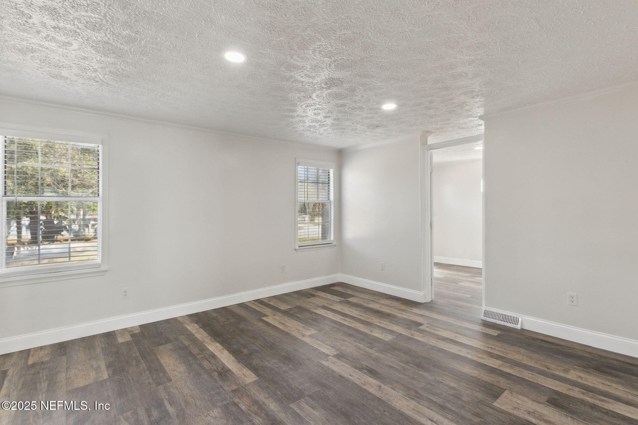 97119 Diamond Street Yulee, FL 32097 - Photo 26 of 42 an empty room with wooden floor and windows