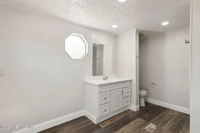 an entryway with a vanity mirror and window