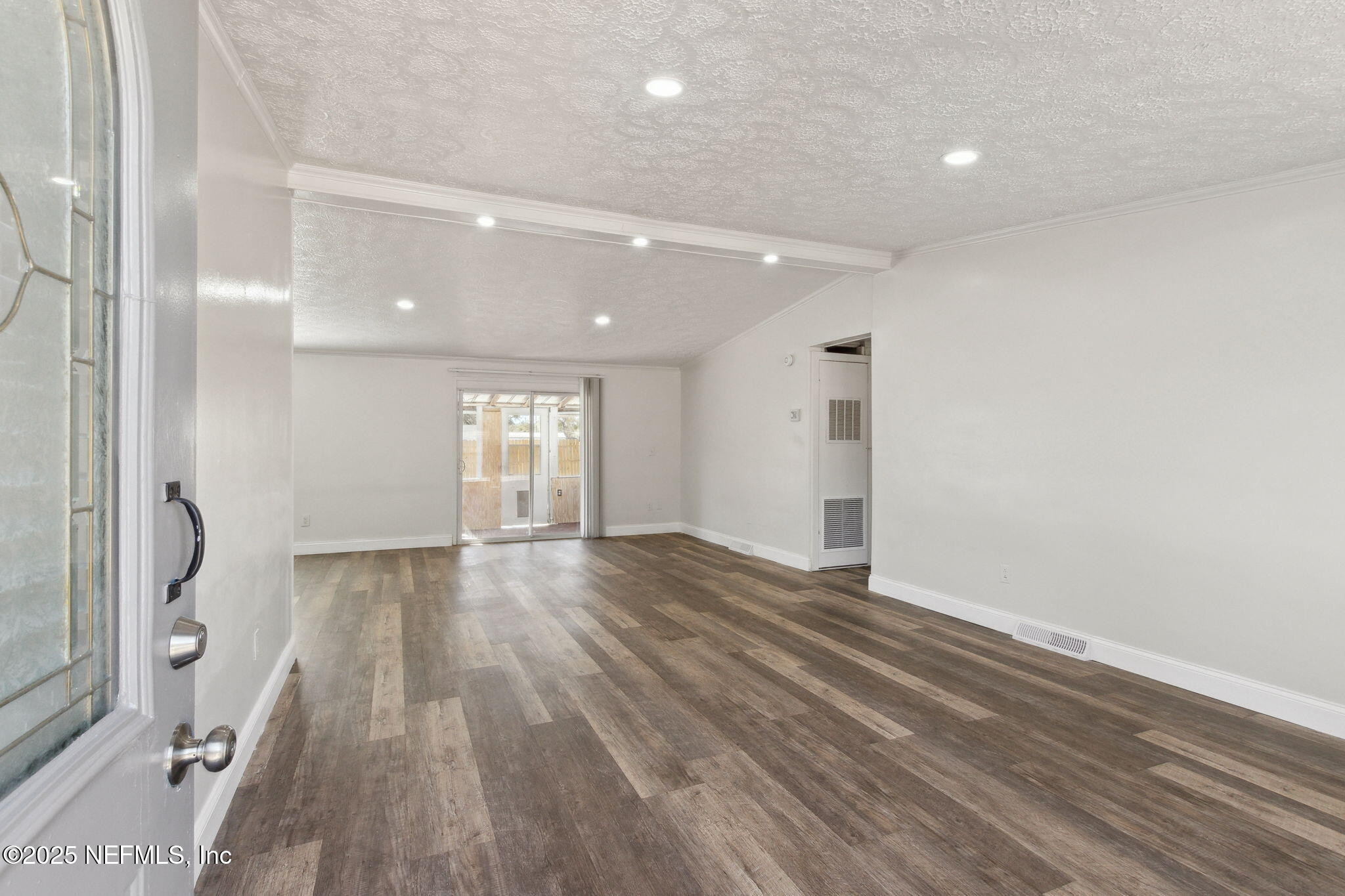 97119 Diamond Street Yulee, FL 32097 - Photo 3 of 42 a view of an empty room with wooden floor and a window