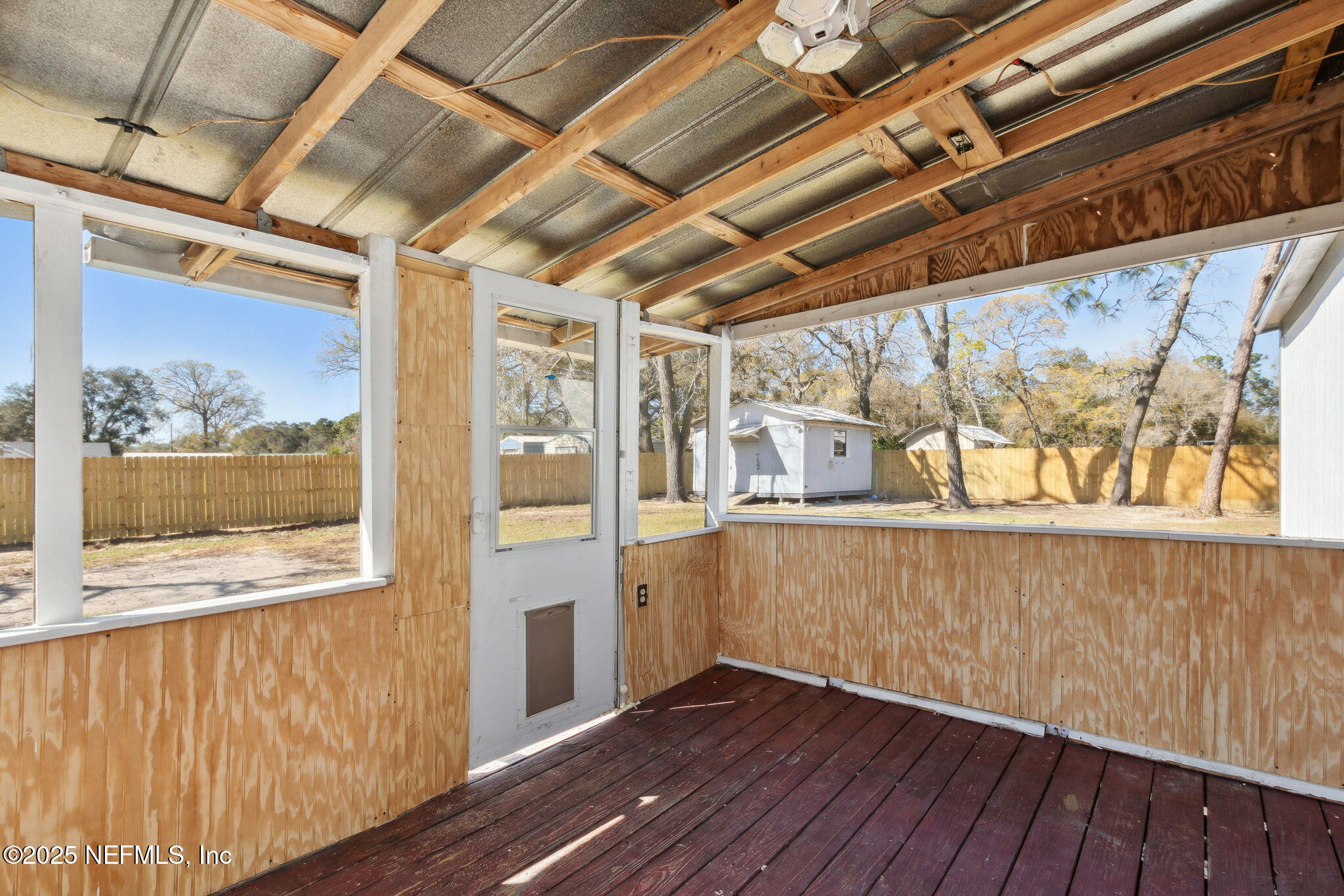97119 Diamond Street Yulee, FL 32097 - Photo 33 of 42 a view of an empty room with wooden floor and a window