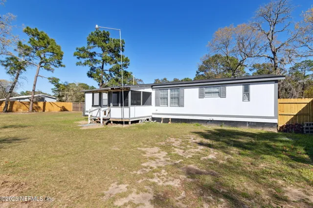 a view of a house with pool and sitting area