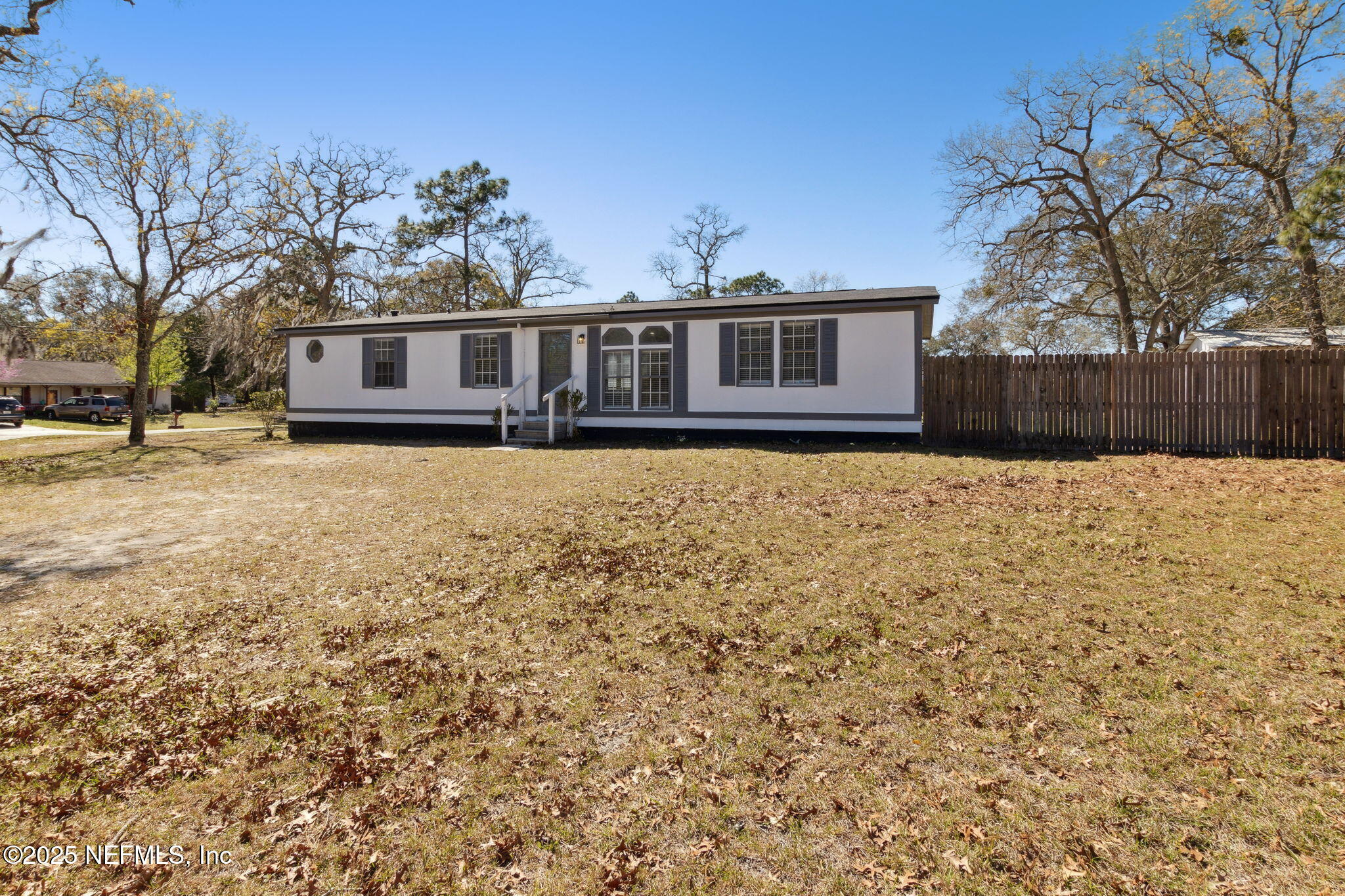 97119 Diamond Street Yulee, FL 32097 - Photo 5 of 42 a front view of a house with a yard
