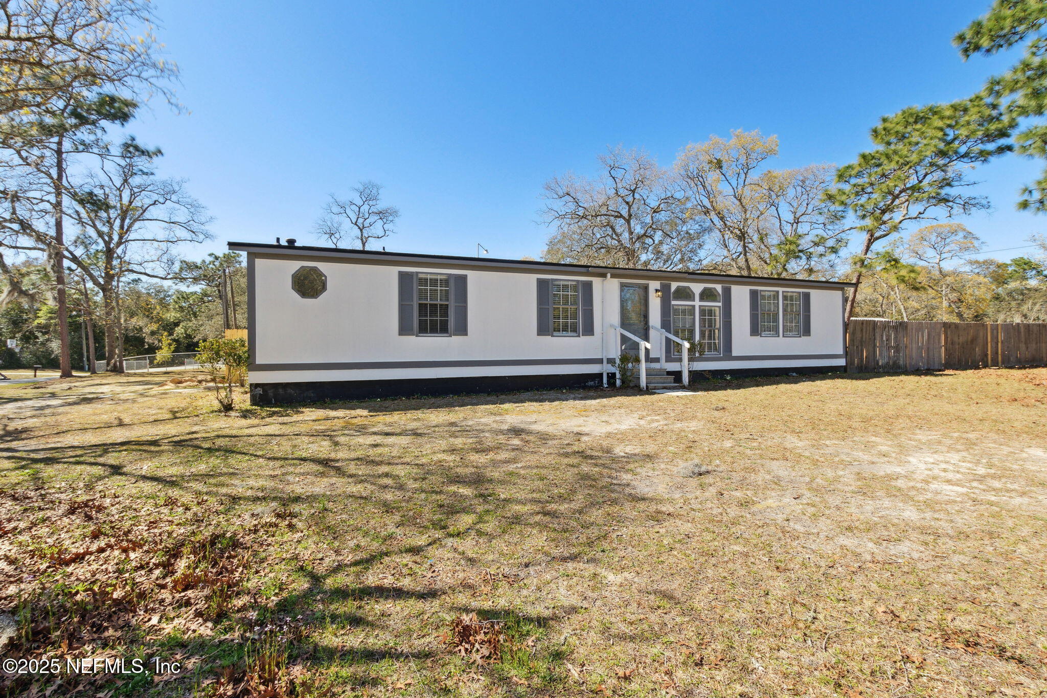 97119 Diamond Street Yulee, FL 32097 - Photo 6 of 42 a front view of a house with a yard
