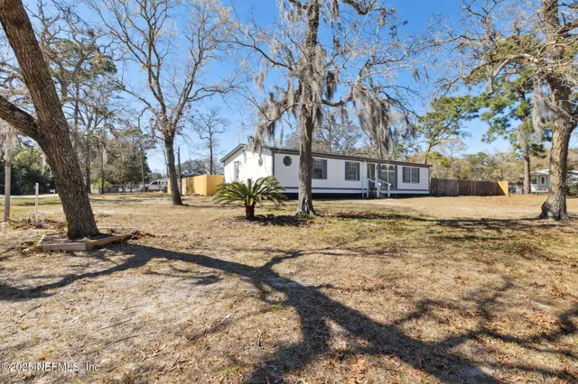 a view of a yard with a tree