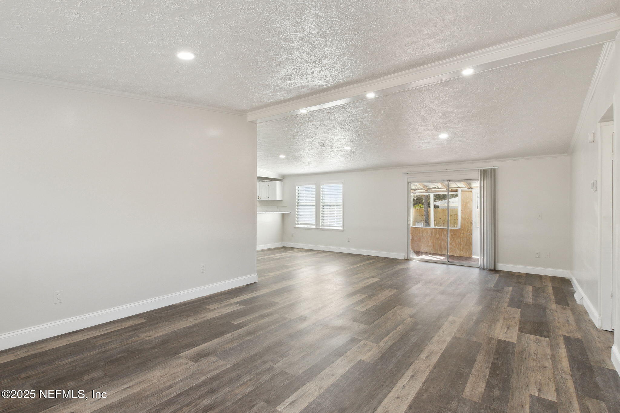 97119 Diamond Street Yulee, FL 32097 - Photo 8 of 42 a view of empty room with wooden floor and fan