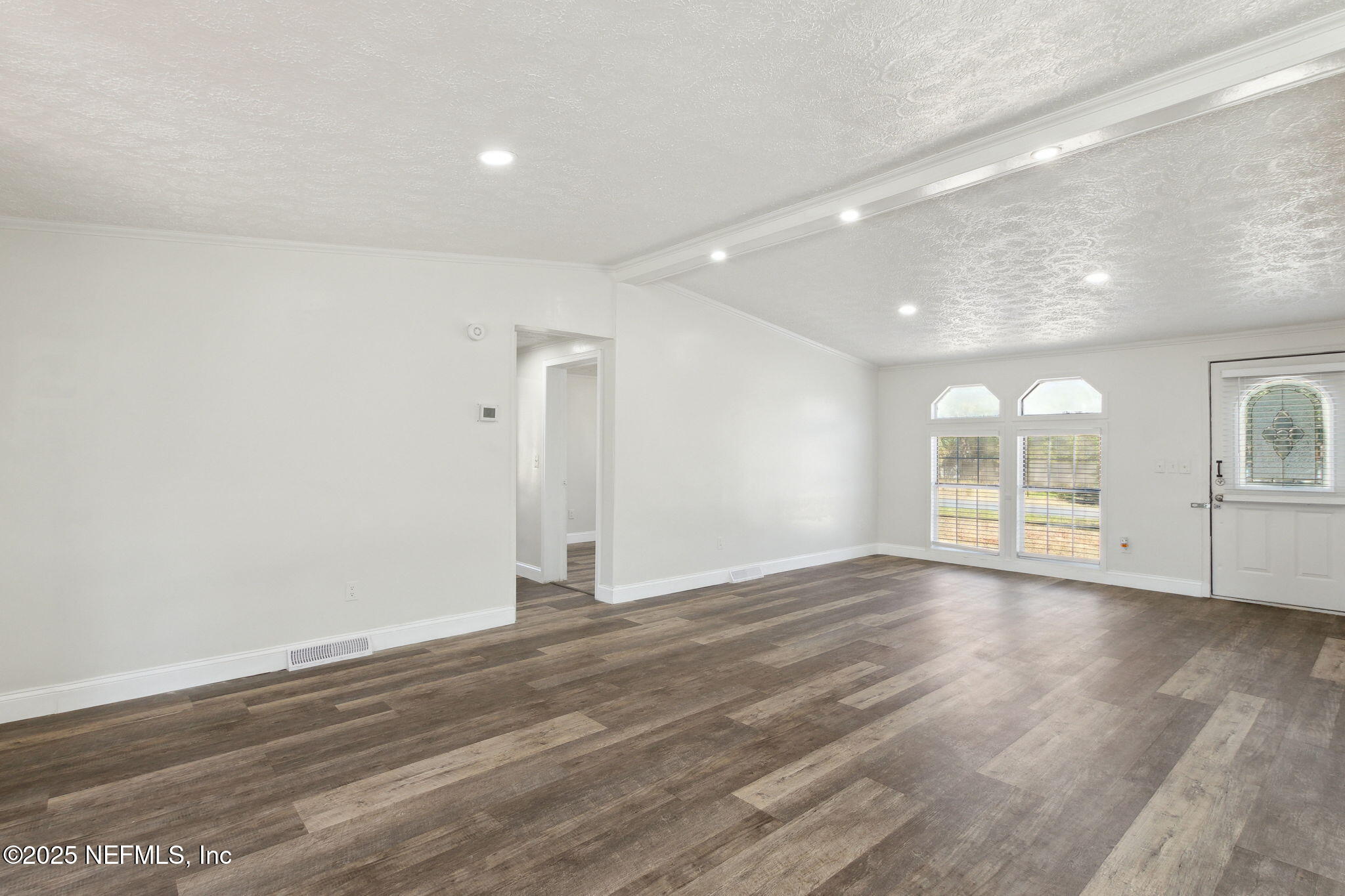 97119 Diamond Street Yulee, FL 32097 - Photo 10 of 42 a view of an empty room with wooden floor and a window