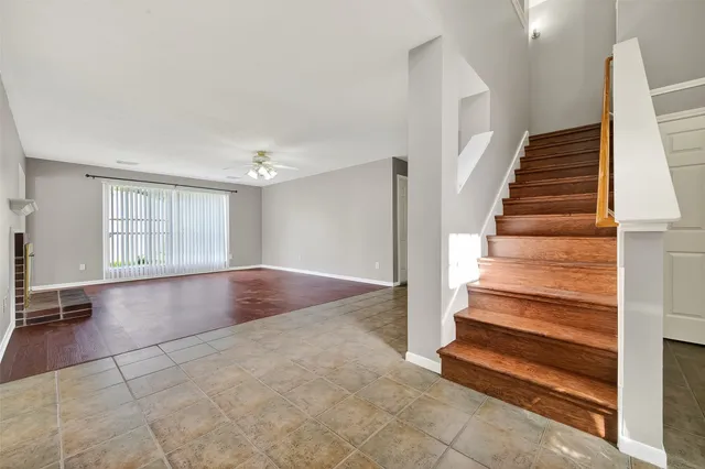 a view of entryway with wooden floor and stairs